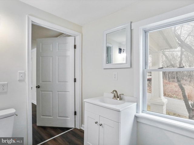 bathroom featuring vanity, hardwood / wood-style floors, and toilet