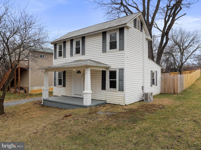 view of front of property featuring a front yard and central air condition unit