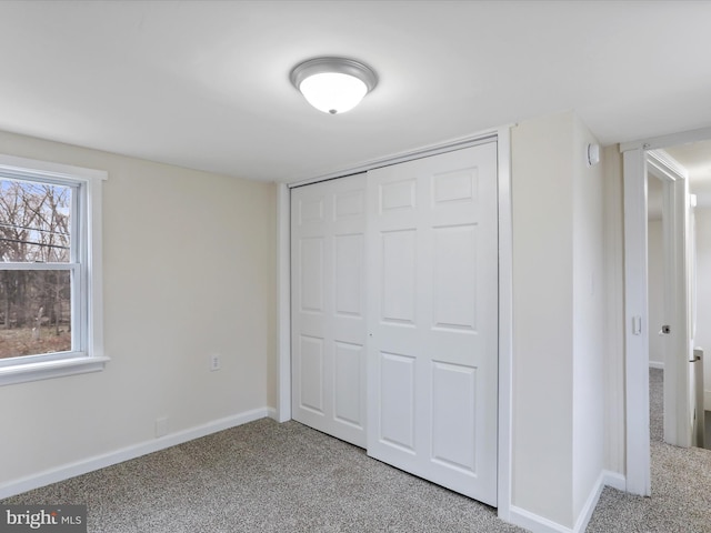 unfurnished bedroom with carpet and a closet