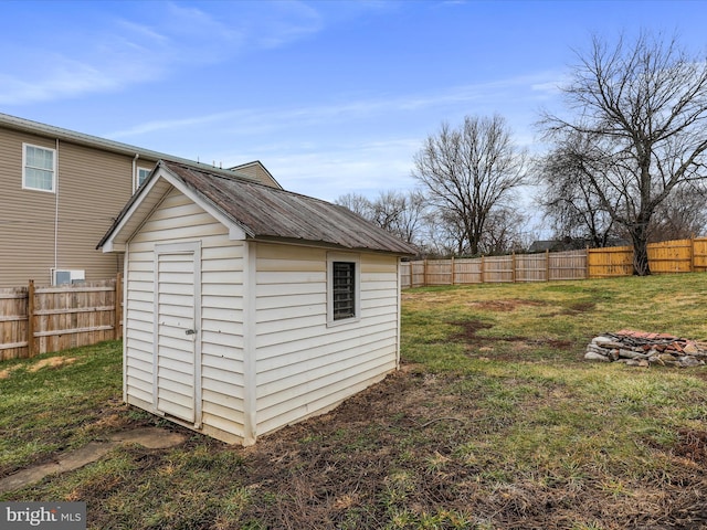 view of outbuilding with a yard