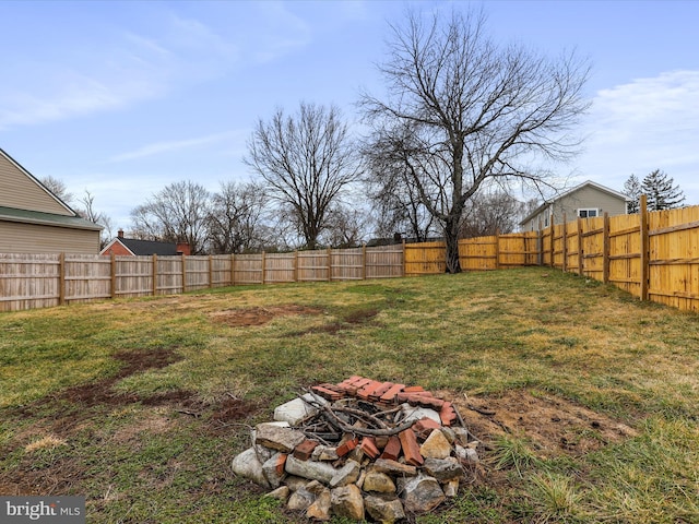 view of yard with a fire pit