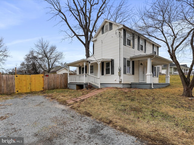 view of property exterior with covered porch and a lawn