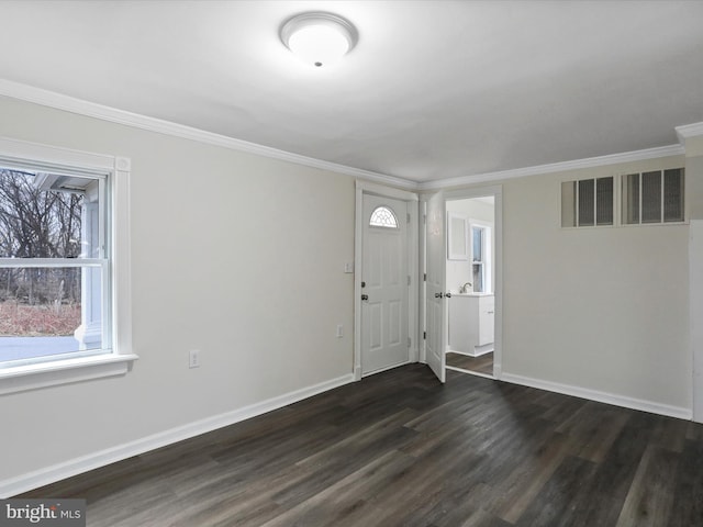 foyer with ornamental molding and dark hardwood / wood-style flooring