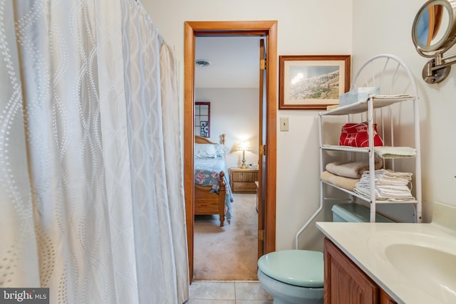 bathroom featuring toilet, vanity, and tile patterned floors