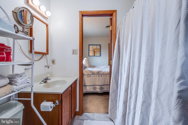 bathroom featuring tile patterned flooring and vanity