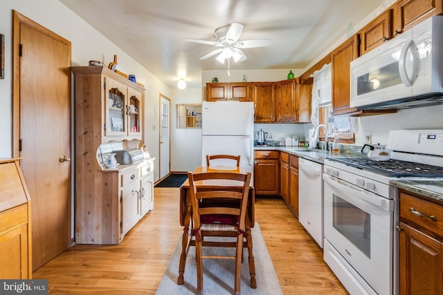 kitchen with ceiling fan, light hardwood / wood-style flooring, white appliances, and sink