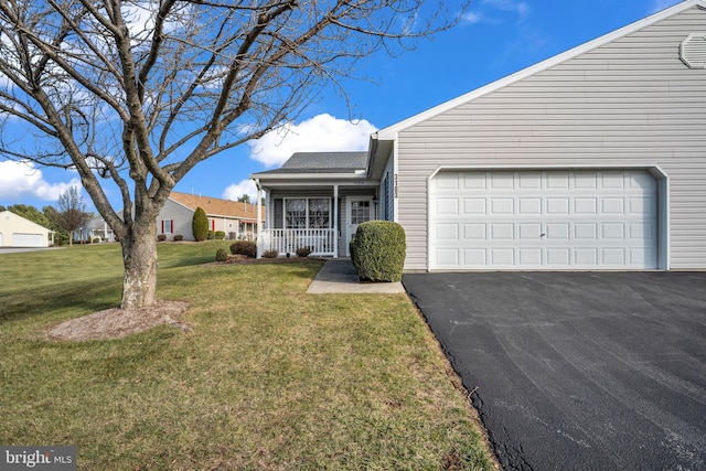 view of front of property with a front lawn, covered porch, and a garage