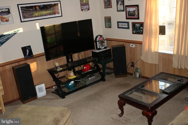 living room featuring light carpet and wooden walls