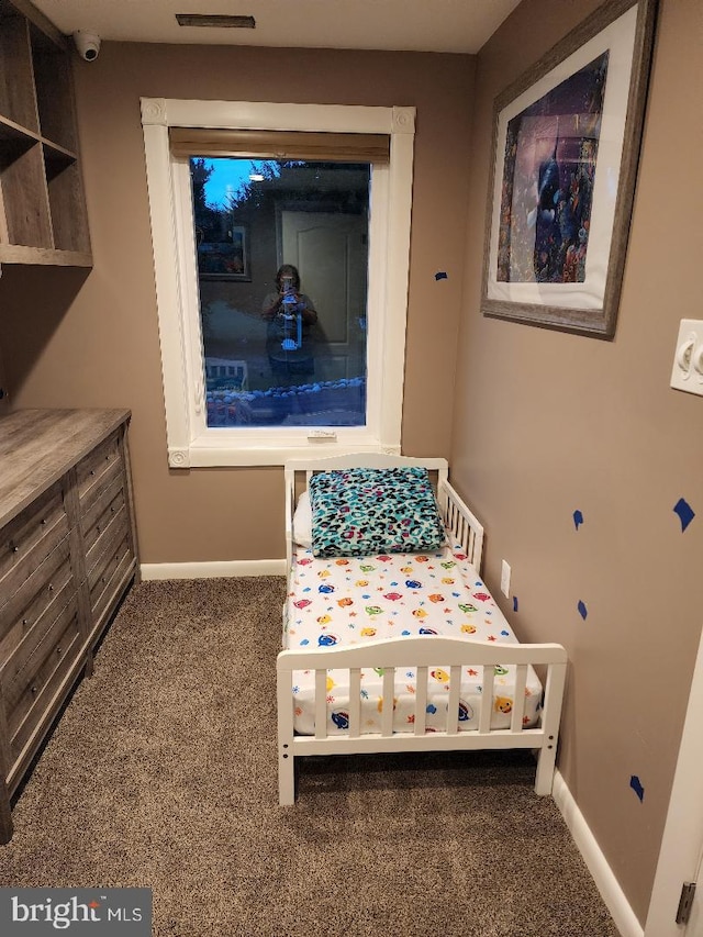 bedroom featuring dark carpet