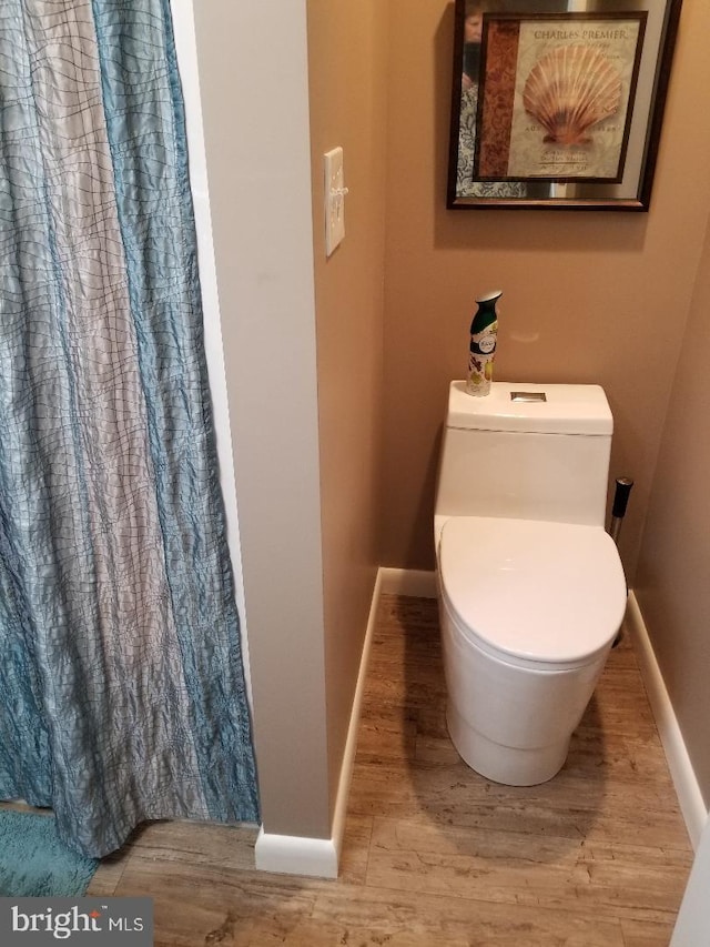 bathroom featuring hardwood / wood-style floors and toilet