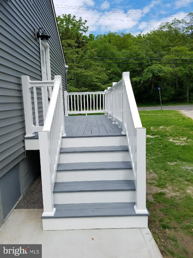 wooden terrace with a yard