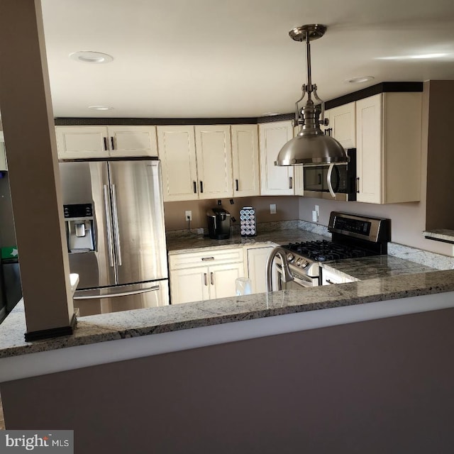 kitchen with kitchen peninsula, dark stone counters, stainless steel appliances, pendant lighting, and white cabinetry