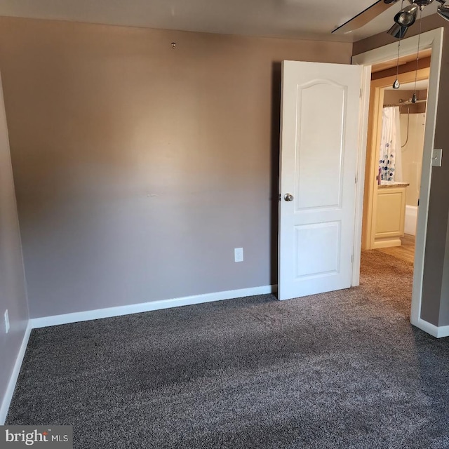 spare room featuring ceiling fan and carpet floors