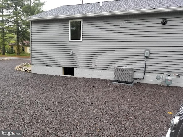 view of side of home featuring cooling unit