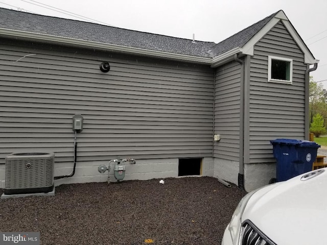 view of side of home with central AC unit