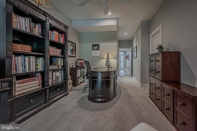 living area with light carpet and ceiling fan