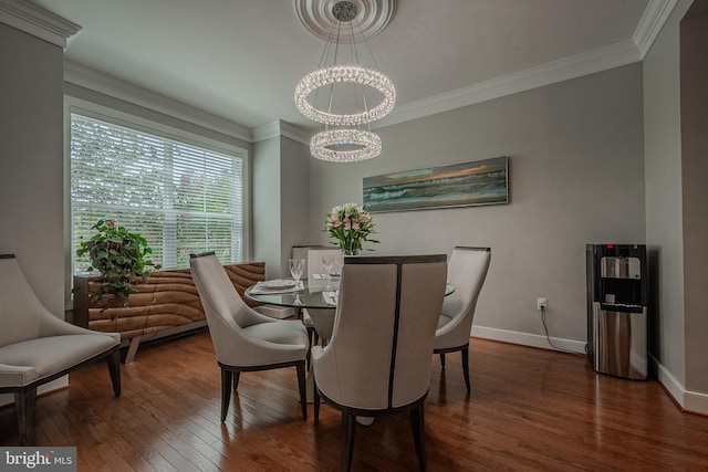 dining space featuring hardwood / wood-style floors, a chandelier, and ornamental molding