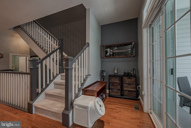 stairs with wood-type flooring