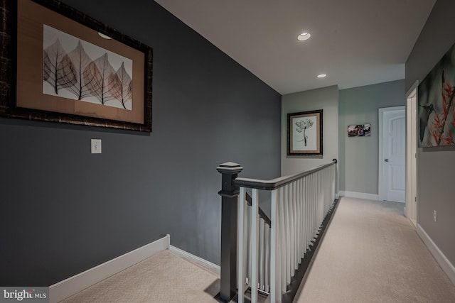 hall with light colored carpet