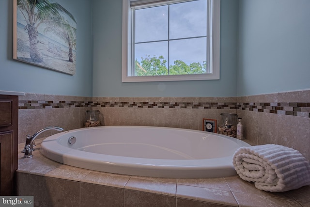 bathroom featuring tiled tub