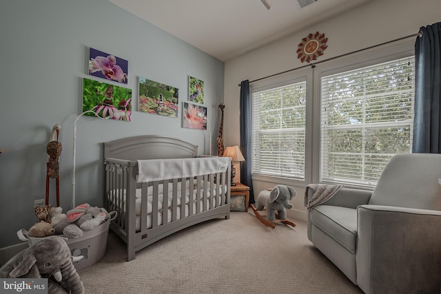 bedroom with carpet flooring and a nursery area