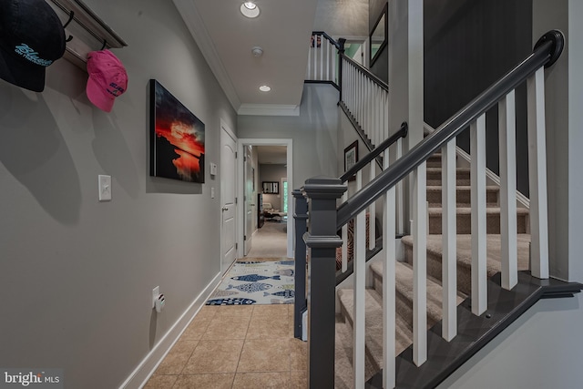 tiled foyer featuring ornamental molding