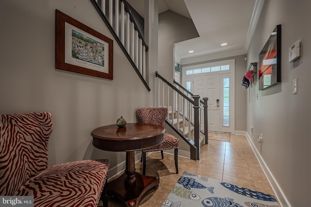 foyer entrance featuring crown molding and light tile patterned flooring