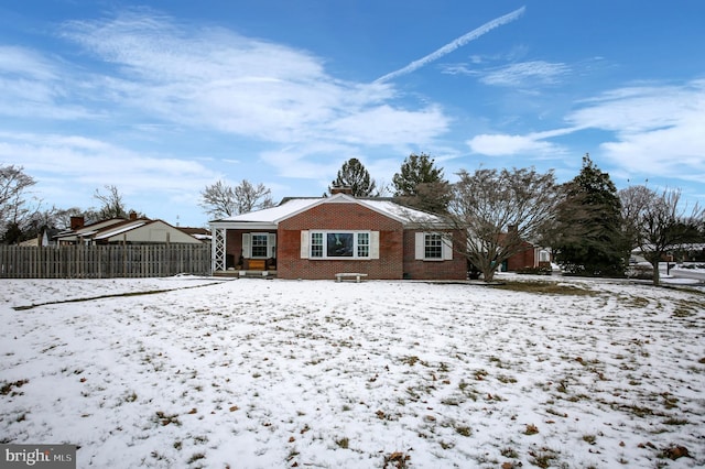 view of snow covered rear of property