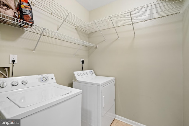 clothes washing area with washer and clothes dryer