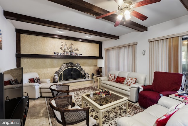 living room with ceiling fan and beamed ceiling