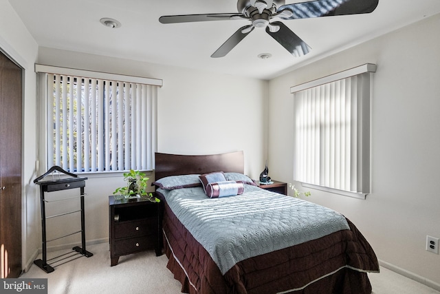 bedroom with light colored carpet and ceiling fan