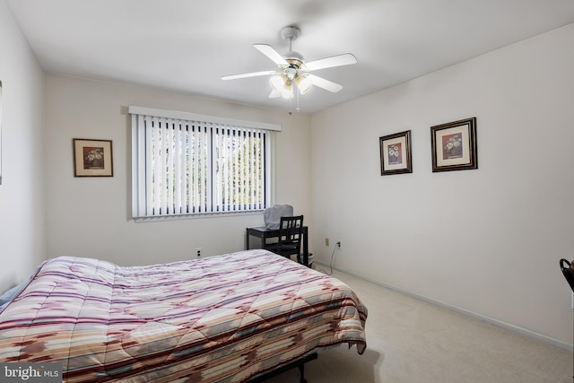 bedroom with ceiling fan and light colored carpet