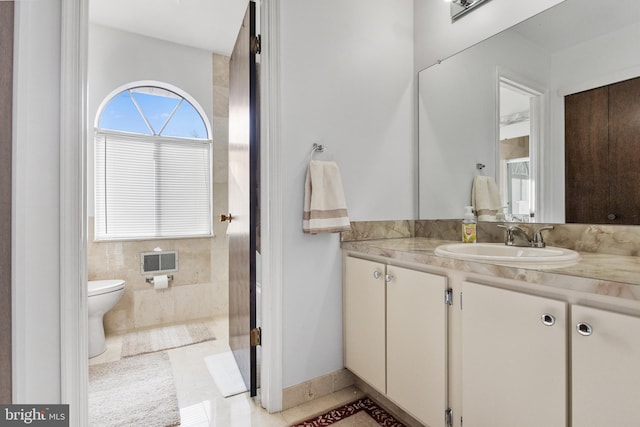 bathroom with tile patterned floors, vanity, and toilet