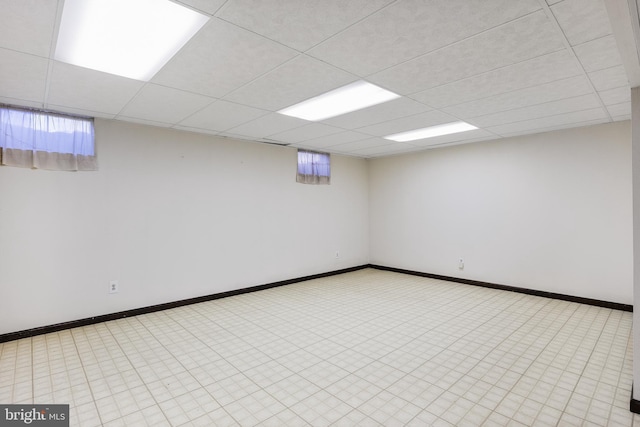 basement with a paneled ceiling