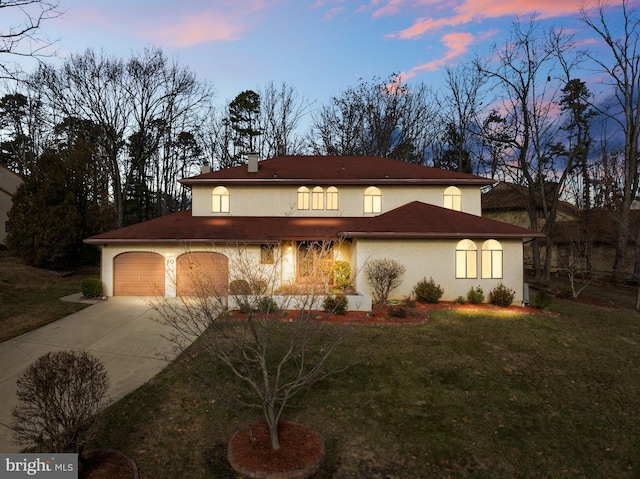 mediterranean / spanish home featuring a lawn and a garage