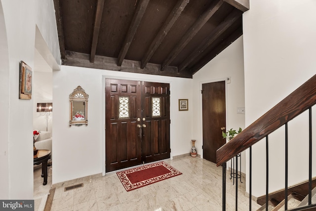 foyer featuring beamed ceiling, high vaulted ceiling, and wood ceiling