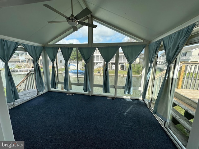 unfurnished sunroom with vaulted ceiling, plenty of natural light, and ceiling fan