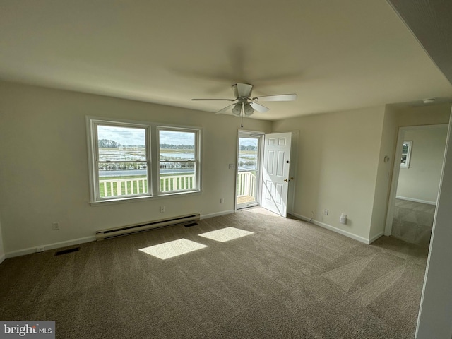 spare room with ceiling fan, carpet floors, and a baseboard radiator