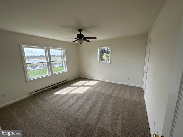 spare room with carpet, plenty of natural light, and a baseboard radiator