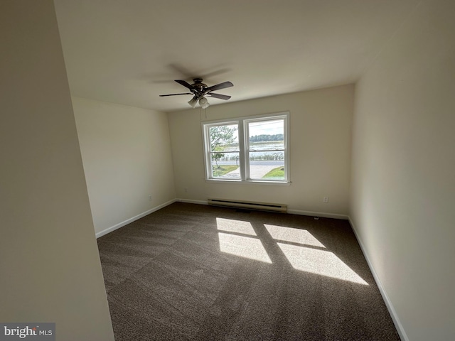 empty room featuring a baseboard radiator, dark carpet, and ceiling fan