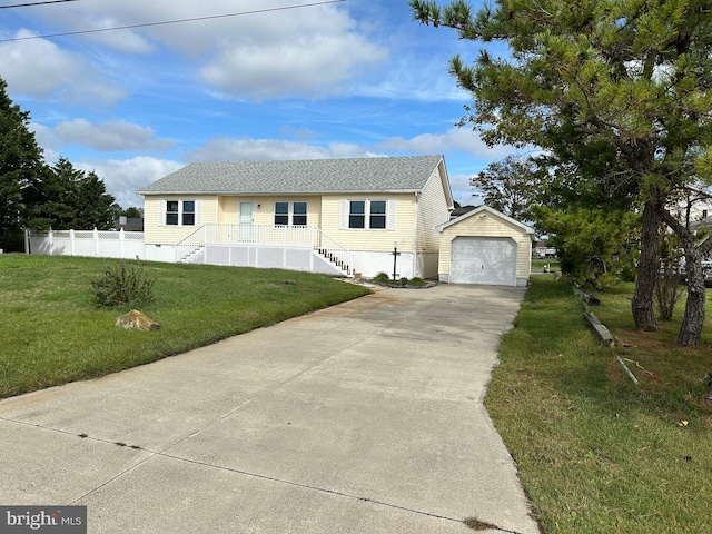 view of front of home featuring an outbuilding, a front lawn, and a garage