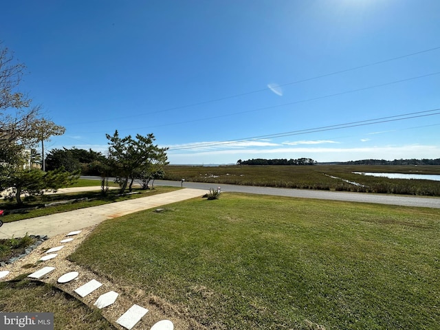 view of yard featuring a rural view and a water view