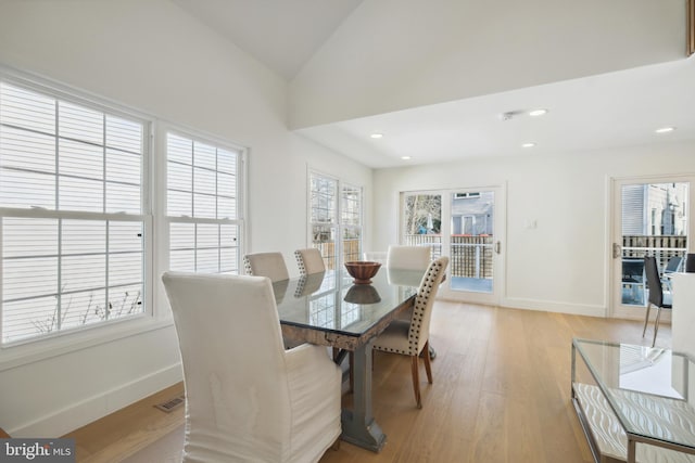 dining area featuring visible vents, baseboards, light wood-type flooring, vaulted ceiling, and recessed lighting