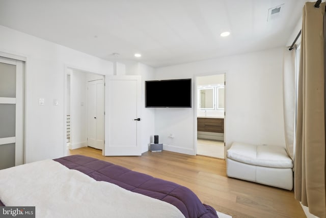 bedroom with visible vents, connected bathroom, baseboards, recessed lighting, and light wood-style floors