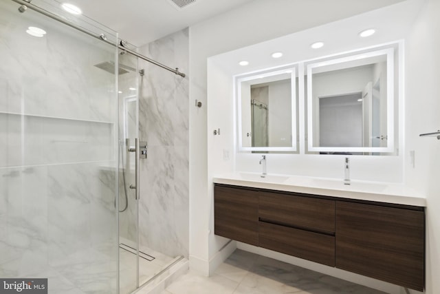 full bathroom featuring a sink and a marble finish shower