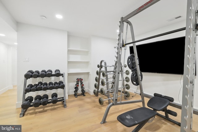 exercise room with recessed lighting, wood finished floors, visible vents, and baseboards