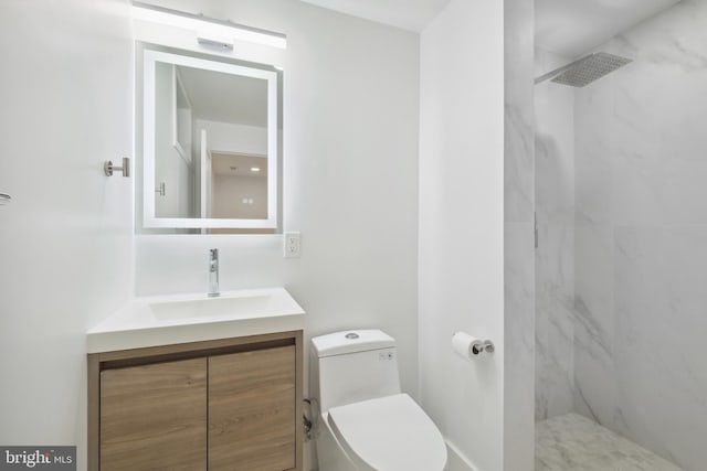 bathroom with a marble finish shower, toilet, and vanity