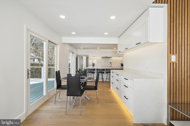 dining area with recessed lighting and light wood-type flooring