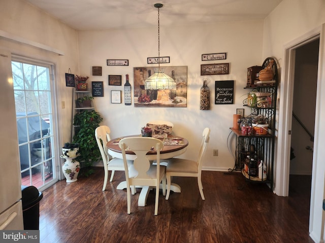 dining room with dark hardwood / wood-style floors