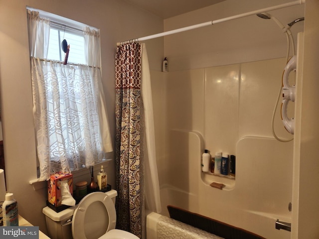 bathroom featuring shower / bath combination with curtain and toilet